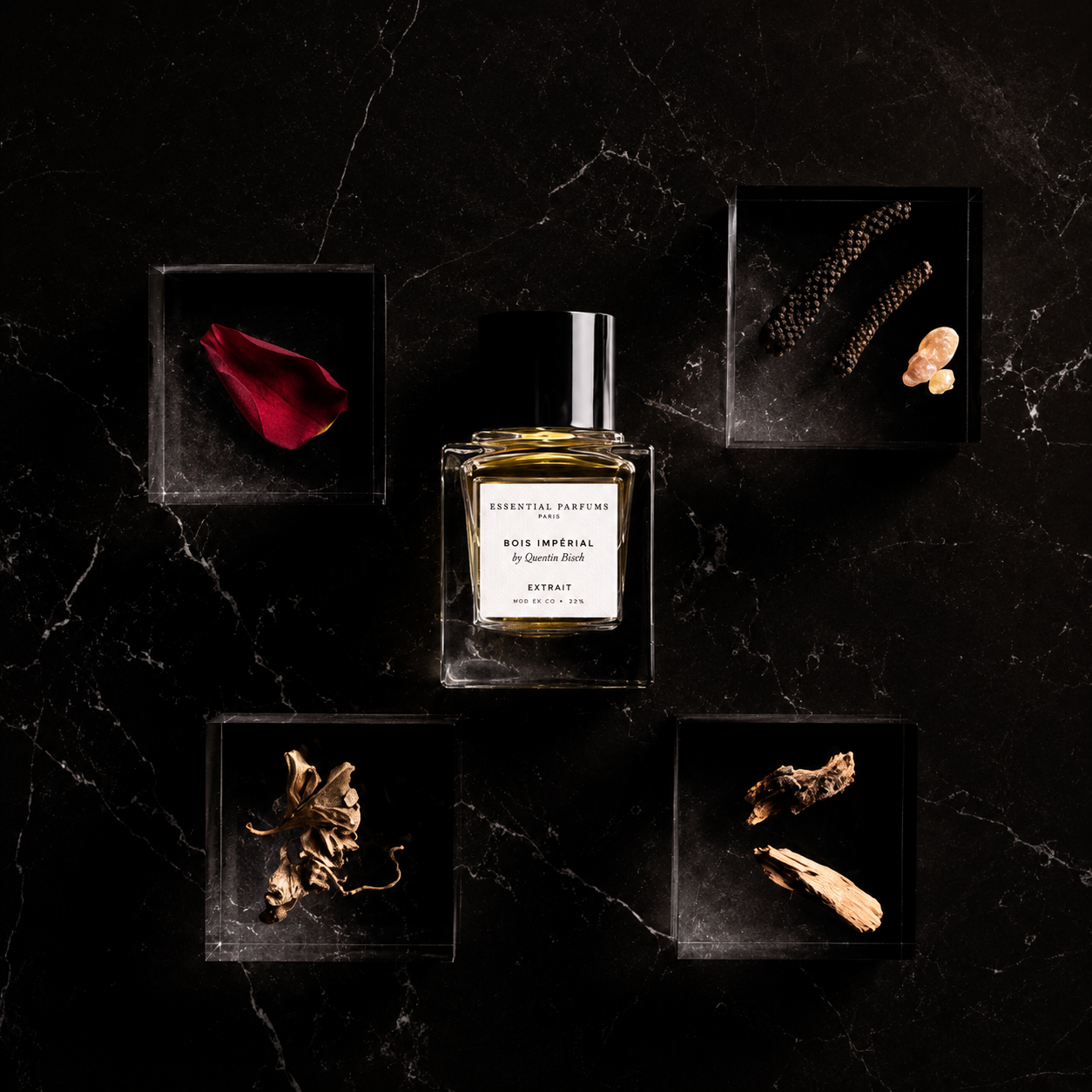 Bois Impérial Extrait d'Essential Parfums, extrait de parfum 30 ml entouré de pétale de rose, poivre Timut, absolu de sapin baumier, bois de cèdre et labdanum sur fond noir.