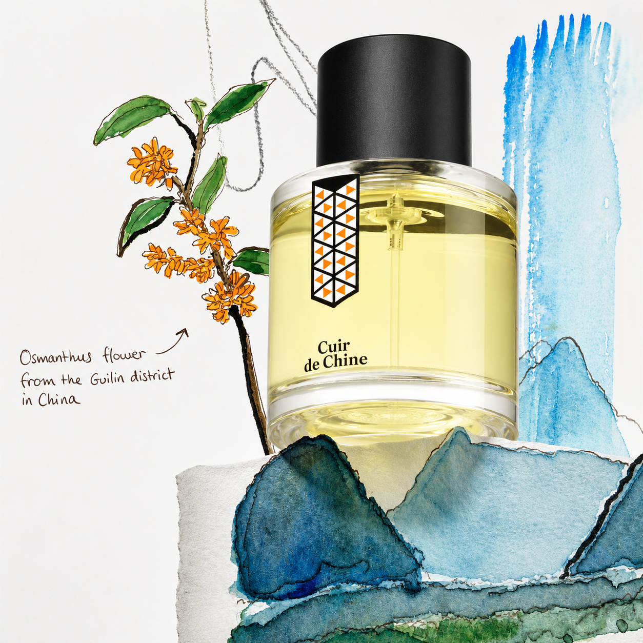 Cuir de Chine de Les Indémodables, eau de parfum 50 ml, mise en scène avec une branche d'osmanthus de Guilin et des montagnes bleues.